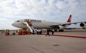 FILE PHOTO: Employees work on a Turkish Airlines plane after its arrival at Aden Abdulle International Airport in Mogadishu Somalia